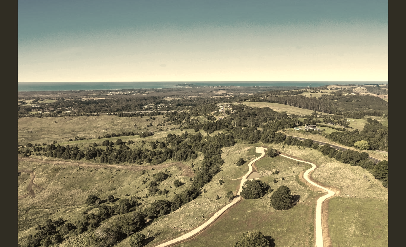 Aerial view of the estate's internal road and ocean beyond